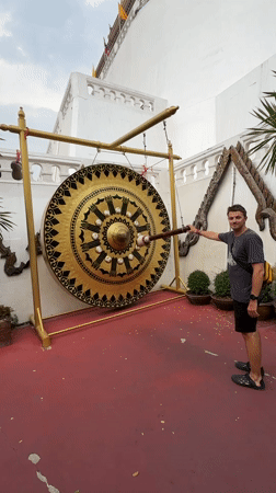 Tourists ring ceremonial gong at Bangkok's Giant Swing shrine