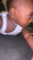 Baby in white shirt observed lying on stomach in Nigeria