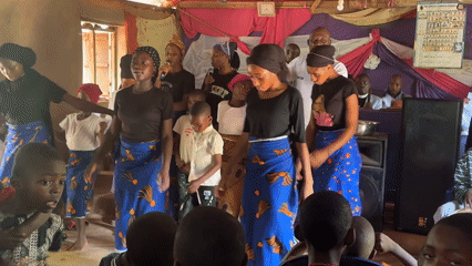 Women perform coordinated dances in church community gathering