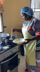 Women in matching aprons prepare food at SKFEST event