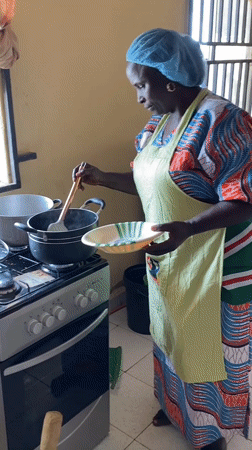 Women in matching aprons prepare food at SKFEST event