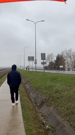 Couple documents rainy morning walk along Chaikovsky railway tracks