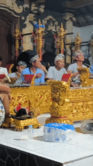 Musicians perform with xylophones as dancers gather under decorated patio