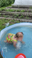 Child enjoys backyard pool time in rural Russian village