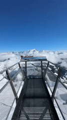 Visitor records alpine panorama from La Clusaz ski resort viewpoint