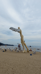 Winged sculpture on a sandy beach in Yantian District