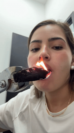 Woman handles burning object with tongs in Mexico