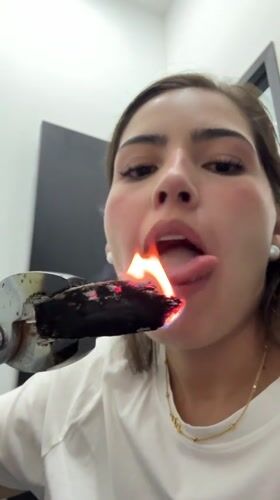 Woman handles burning object with tongs in Mexico