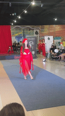 All-red fashion show on a blue runway in Tri Potoka