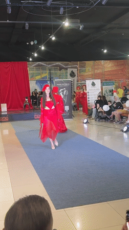 All-red fashion show on a blue runway in Tri Potoka