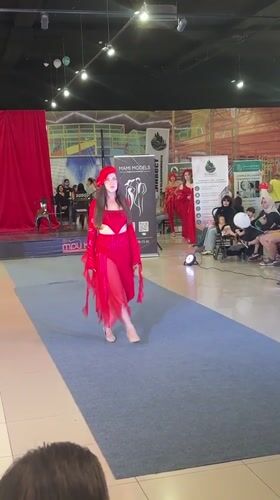 All-red fashion show on a blue runway in Tri Potoka