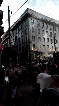 Evening cathedral district with street art, flowers, and public gathering