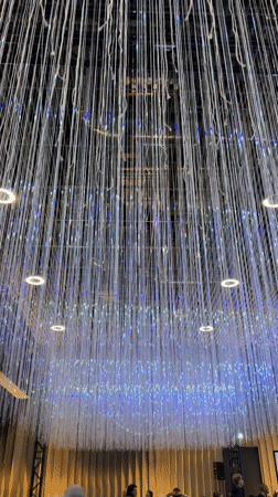Artistic installation with hanging white strands documented in Riga