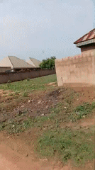Cyclist navigates muddy roads in Nigerian residential area