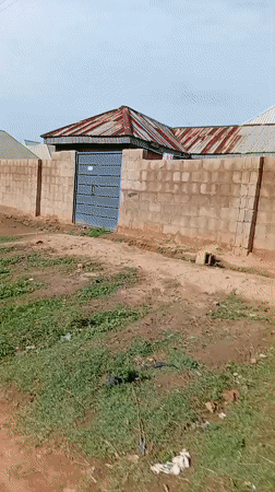 Cyclist navigates muddy roads in Nigerian residential area