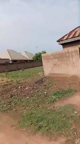 Cyclist navigates muddy roads in Nigerian residential area