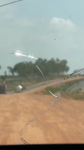 Vehicle journey documented through cracked windshield in Dokwa, Nigeria