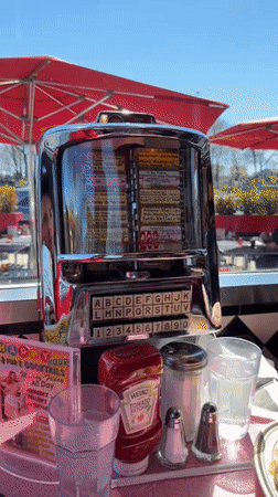 Patrons use vintage jukebox at NYC retro diner