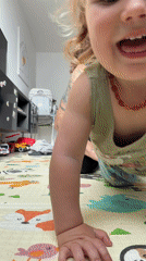 Toddler crawls on floor mat in Kiryat Bialik home