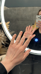 Woman takes mirror selfie showing manicure in Riga