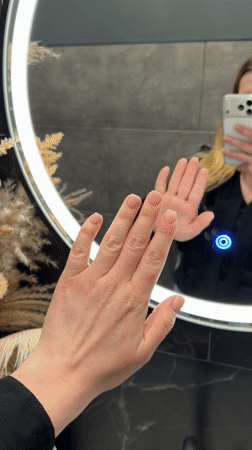 Woman takes mirror selfie showing manicure in Riga