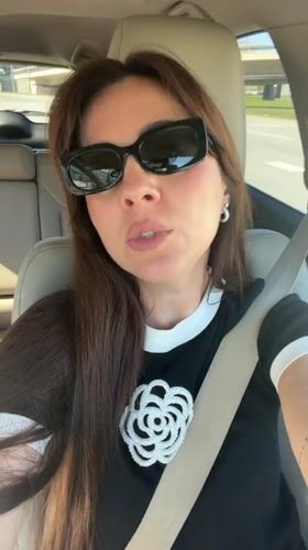 Woman in decorated black shirt observed in car, Riga