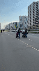 Family with strollers crosses street near playground in Saint Petersburg