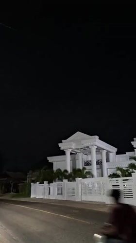 Illuminated white building observed at night in Lancang Barat
