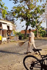 Morning street life and cleanup outside a Dahanrejo food stall
