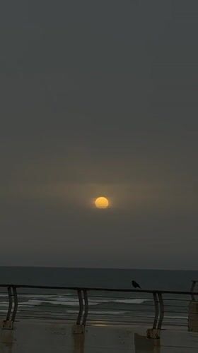 Misty sunset captured over Tel-Aviv coastline