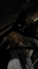 Woman sings along to music in car in Montenegro