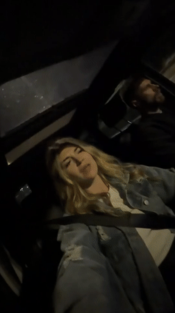 Woman sings along to music in car in Montenegro