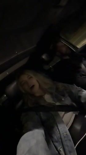 Woman sings along to music in car in Montenegro