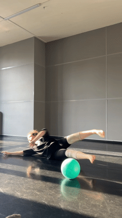 Woman performs gymnastics in sunlit Saint Petersburg room