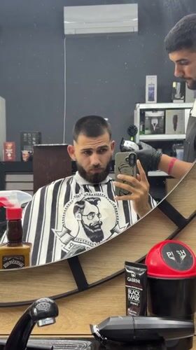 Man gets haircut at Bulgarian barbershop
