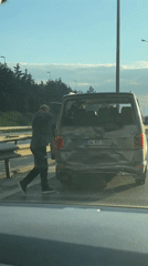 Person stands by damaged van on Turkish highway