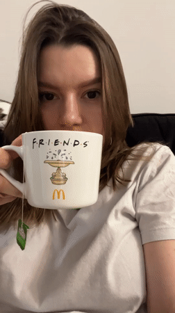 Woman enjoys quiet evening with mug and cat in Limassol