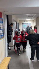 Young hockey players skate through hallway in Izhevsk