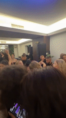 Crowded celebration with colorful lighting captured in Blagoevgrad banquet hall