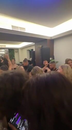 Crowded celebration with colorful lighting captured in Blagoevgrad banquet hall