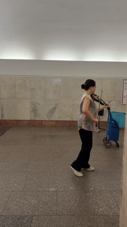 Violinist plays a pedestrian walkway in central Moscow
