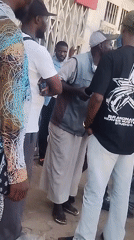 Street gatherings and billboard maintenance observed in commercial area