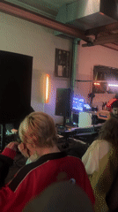 DJ performs for small crowd at evening event in The Hague