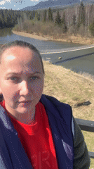 Woman documents scenic river valley views in Kordonnyi, Russia