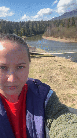 Woman documents scenic river valley views in Kordonnyi, Russia