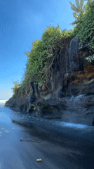 Waterfall meets black sand at Yeh Gangga Beach, Bali