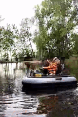 Child steers boat on Czech waterway with adult passenger