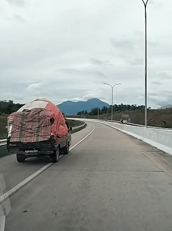 Loaded truck observed on Indonesian highway near Sihomlhok