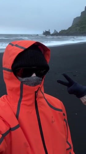 Tourist visits Iceland's famous black sand beach at Vik