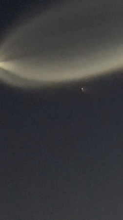 Bright contrail streaks across Los Angeles night sky